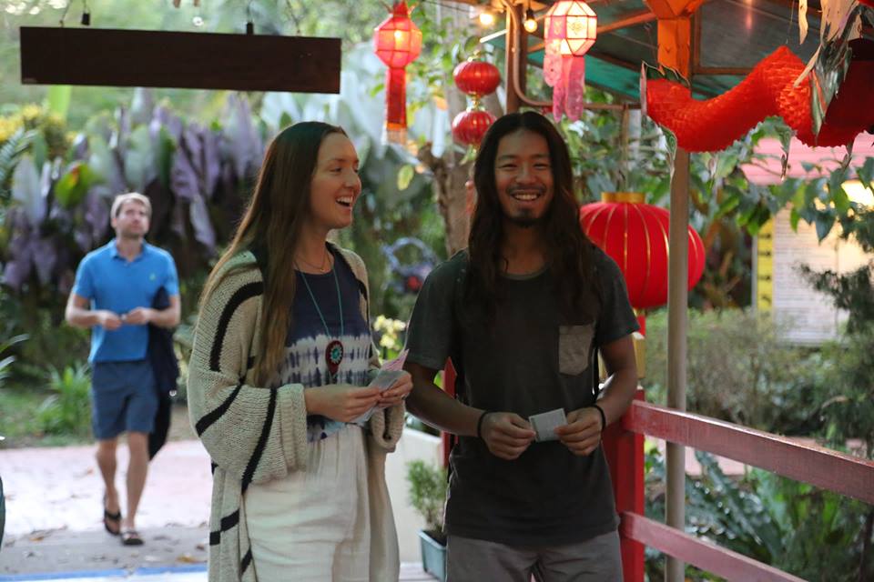 A Taoist couple relaxing and walking over a bridge at the Tao Garden resort